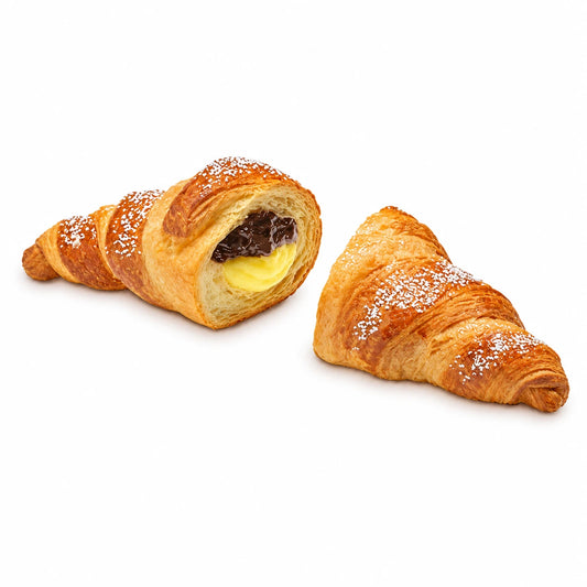 Croissant XL Guinda-Vainilla cortado sobre fondo neutro, mostrando la crema de vainilla y el relleno de Amarena
