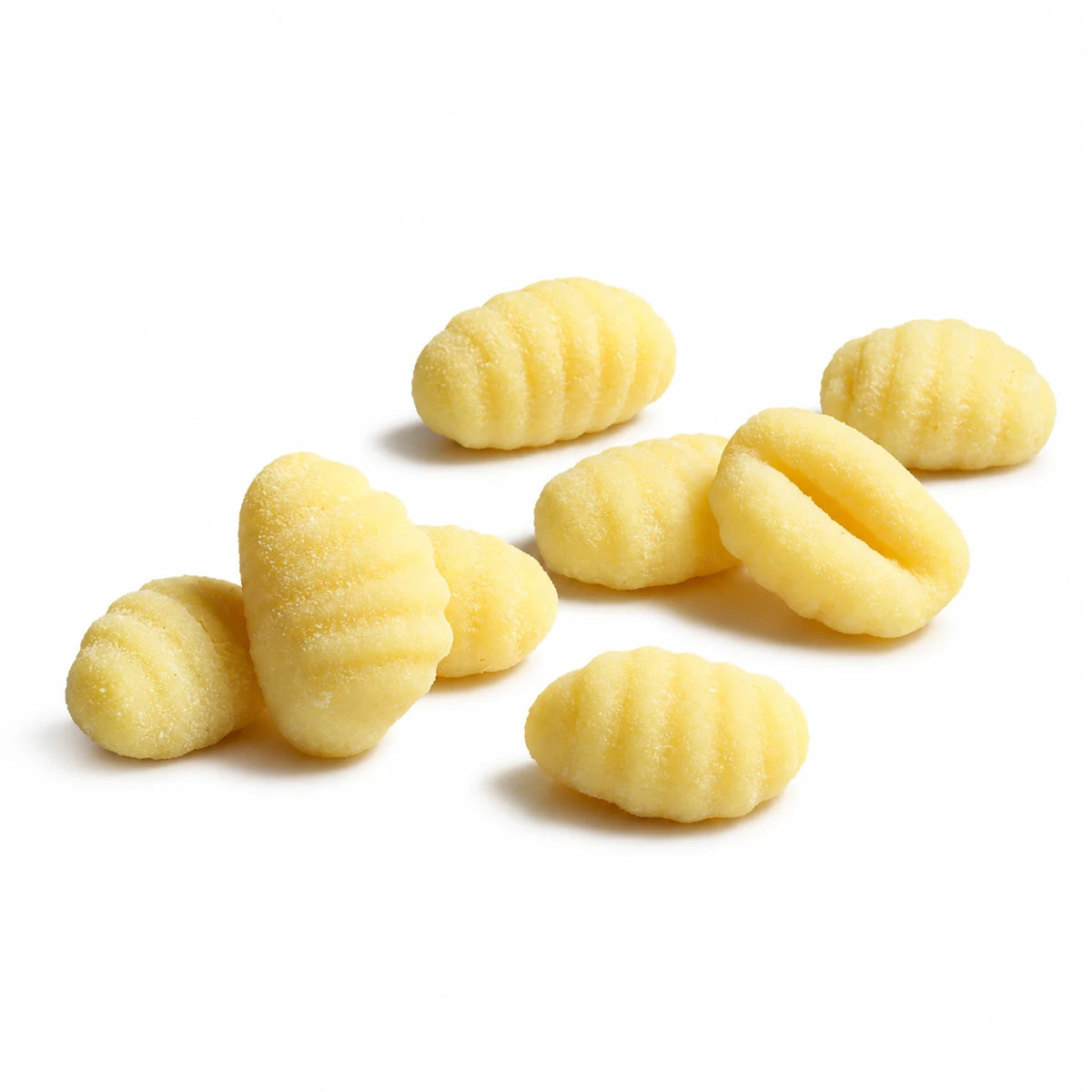 Potato gnocchi with typical ridges, loose on a white background